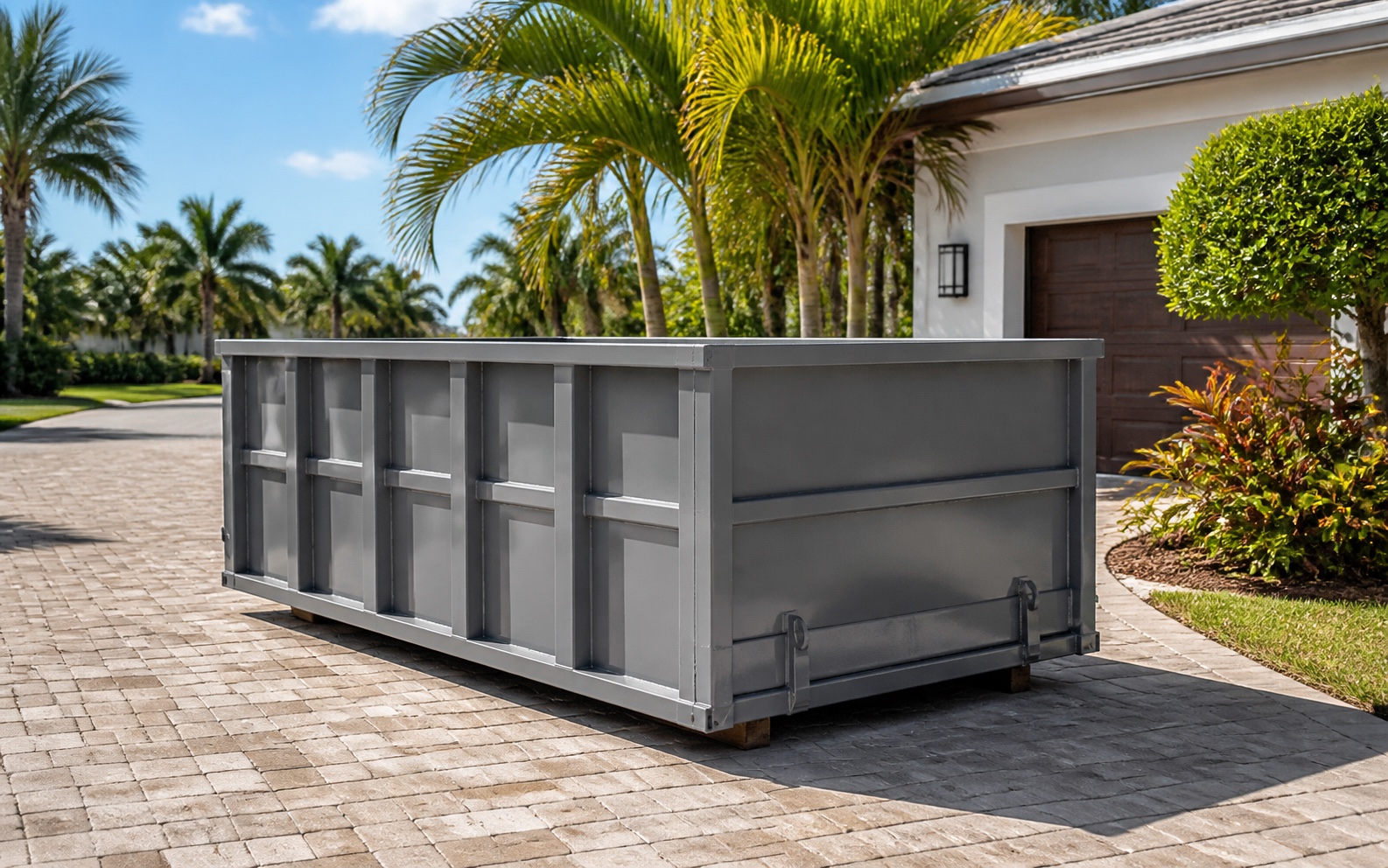 Clean roll-off dumpster positioned on a Florida residential driveway